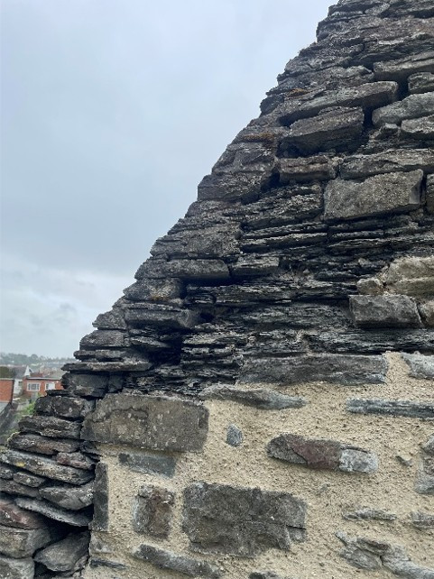 Image of a stone wall different sections of mortar repairs