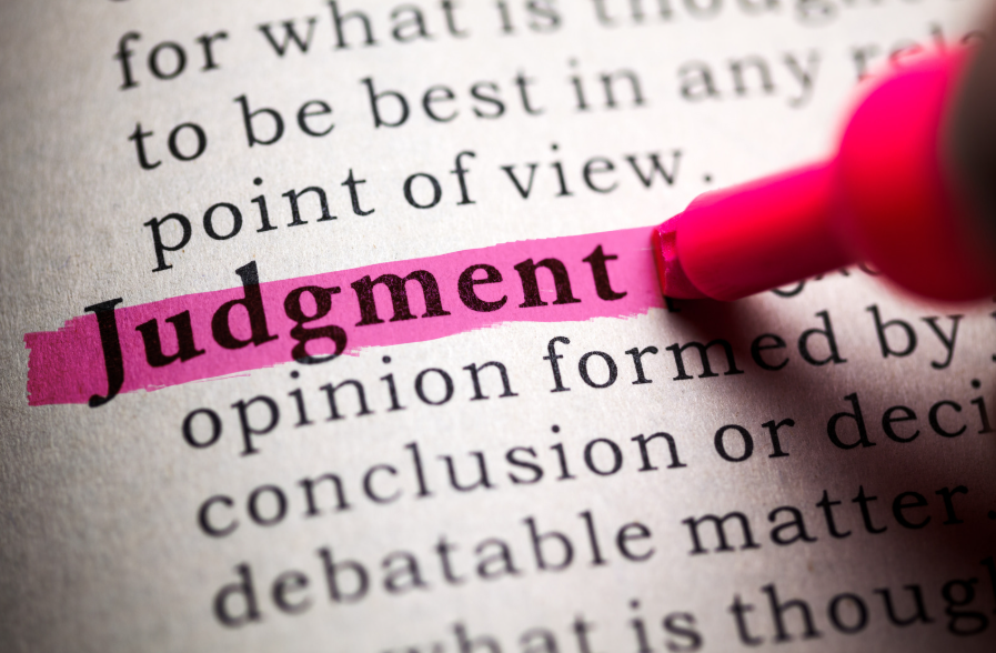 Image showing the word judgement in a dictionary being highlighted